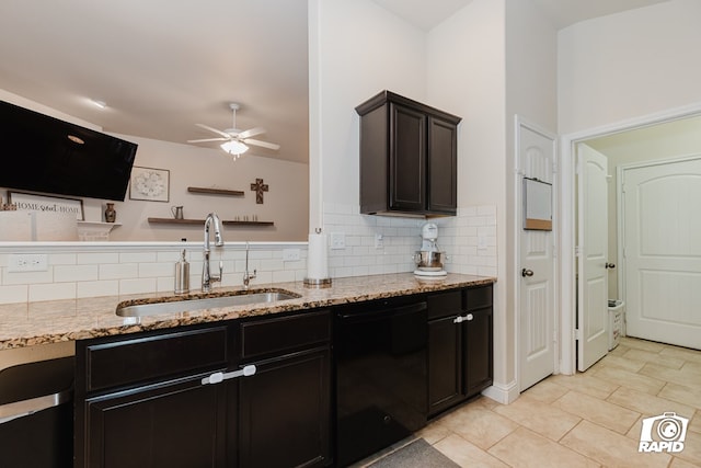 kitchen with ceiling fan, sink, light stone countertops, black dishwasher, and decorative backsplash