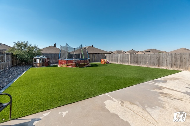 view of yard featuring a playground and a trampoline