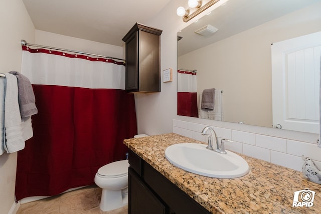 bathroom featuring tile patterned floors, decorative backsplash, vanity, and toilet