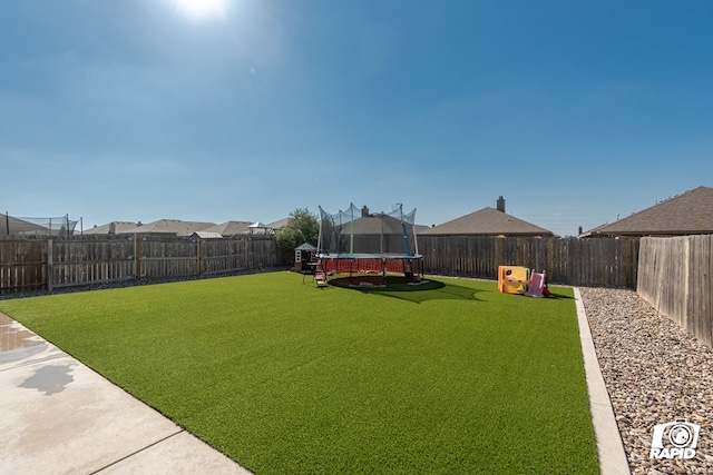 view of yard with a trampoline