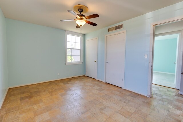 unfurnished bedroom featuring ceiling fan