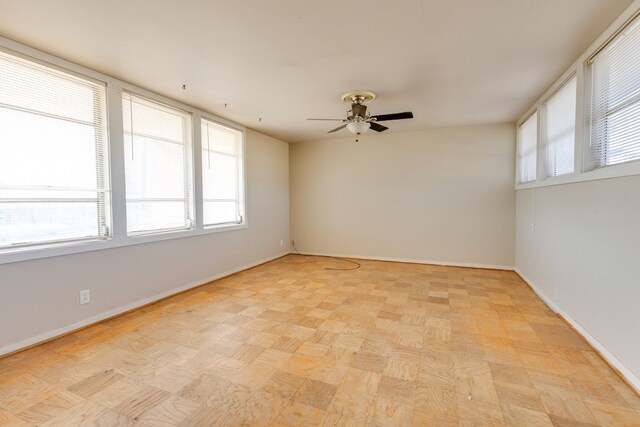 spare room with ceiling fan and light parquet flooring