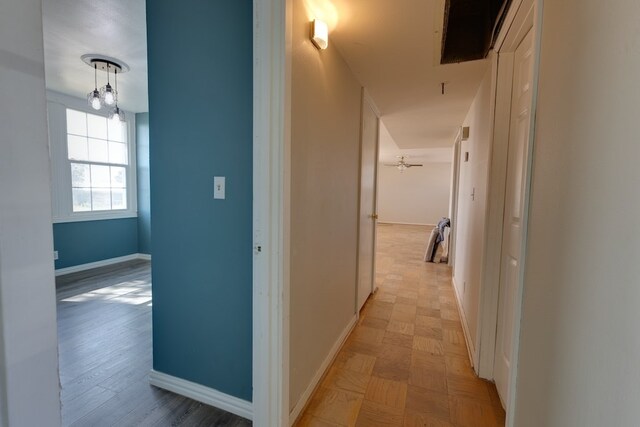 corridor with light hardwood / wood-style flooring