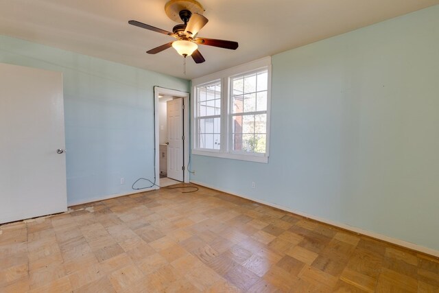 unfurnished room with ceiling fan