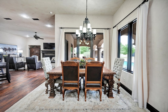 dining space with a chandelier, a ceiling fan, wood finished floors, ornate columns, and recessed lighting