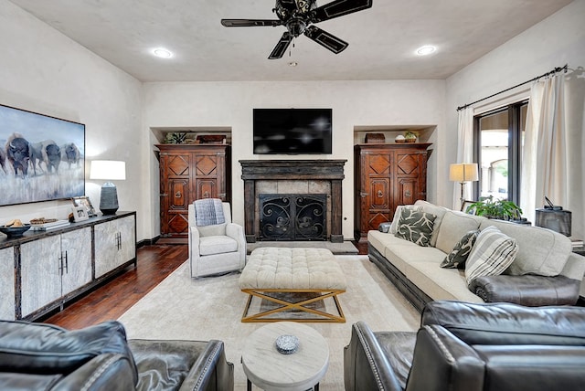 living room featuring ceiling fan, wood finished floors, a fireplace, and recessed lighting