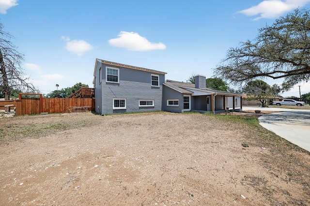 2502 W Cuthbert Ave, Midland, TX 79701 - back of property featuring a chimney and concrete driveway