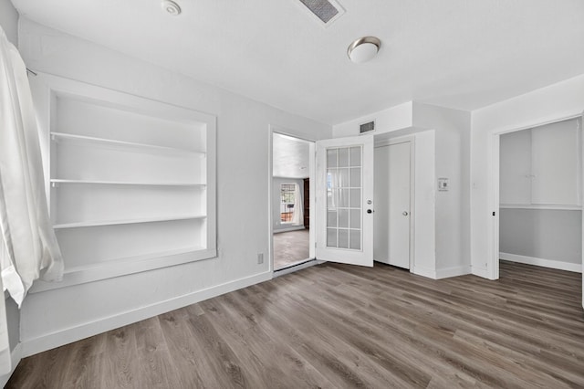 2502 W Cuthbert Ave, Midland, TX 79701 - unfurnished bedroom with wood finished floors and baseboards