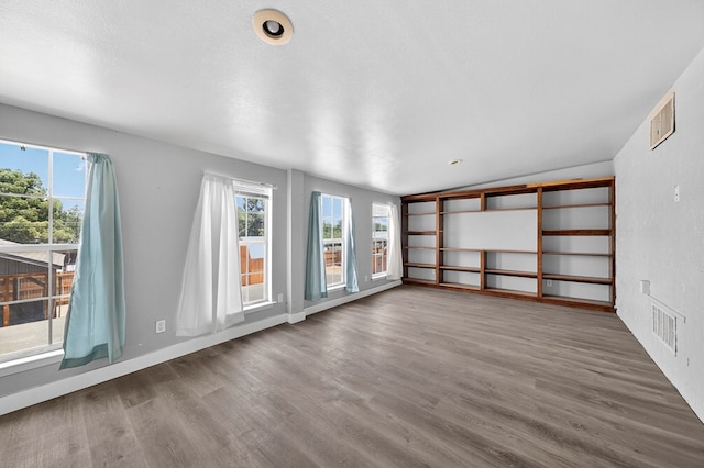 2502 W Cuthbert Ave, Midland, TX 79701 - unfurnished room with wood finished floors and lofted ceiling