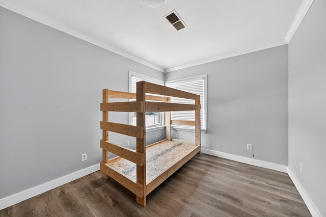 2502 W Cuthbert Ave, Midland, TX 79701 - unfurnished bedroom featuring crown molding and wood finished floors