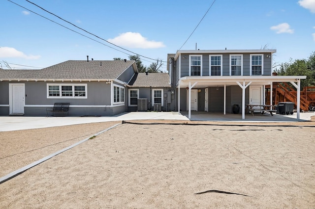 2502 W Cuthbert Ave, Midland, TX 79701 - back of property featuring a shingled roof and a patio area