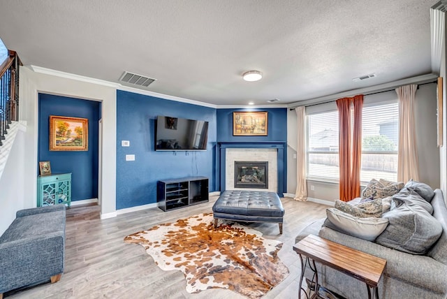 806 Revere Pl, Midland, TX 79706 - living area featuring wood finished floors, ornamental molding, a textured ceiling, and visible vents