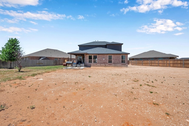 806 Revere Pl, Midland, TX 79706 - rear view of house featuring brick siding, a fenced backyard, a patio area, and roof with shingles