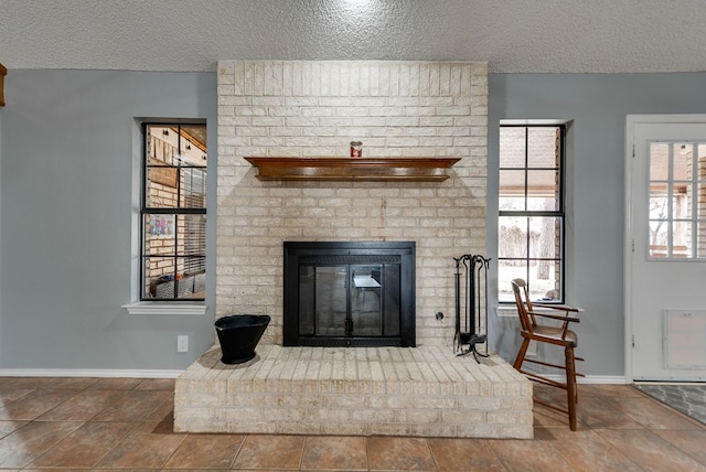 details with a brick fireplace and a textured ceiling