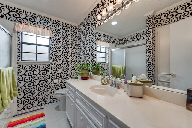 bathroom featuring toilet, a textured ceiling, ornamental molding, vanity, and tile patterned flooring