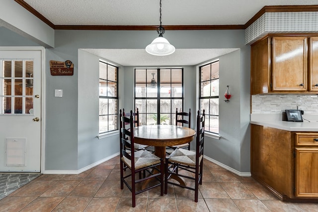 tiled dining room featuring crown molding and a textured ceiling