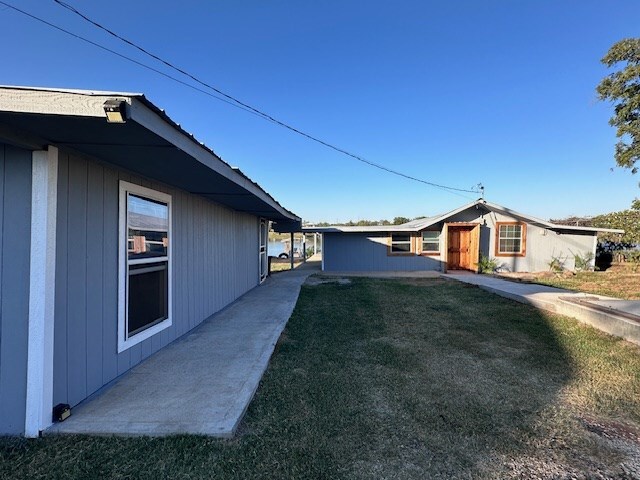 view of property exterior with a yard