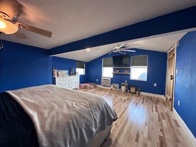 bedroom with vaulted ceiling with beams, light wood-type flooring, and ceiling fan