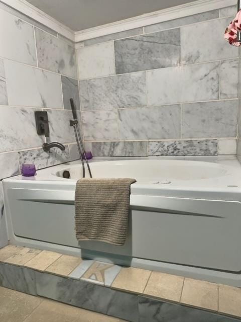 bathroom with tile patterned flooring, a bathtub, and crown molding