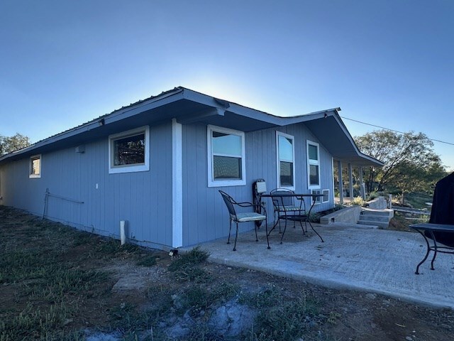 view of side of home with a patio area