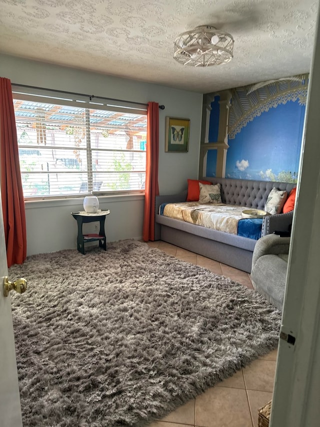 sitting room with tile patterned flooring, a textured ceiling, and plenty of natural light