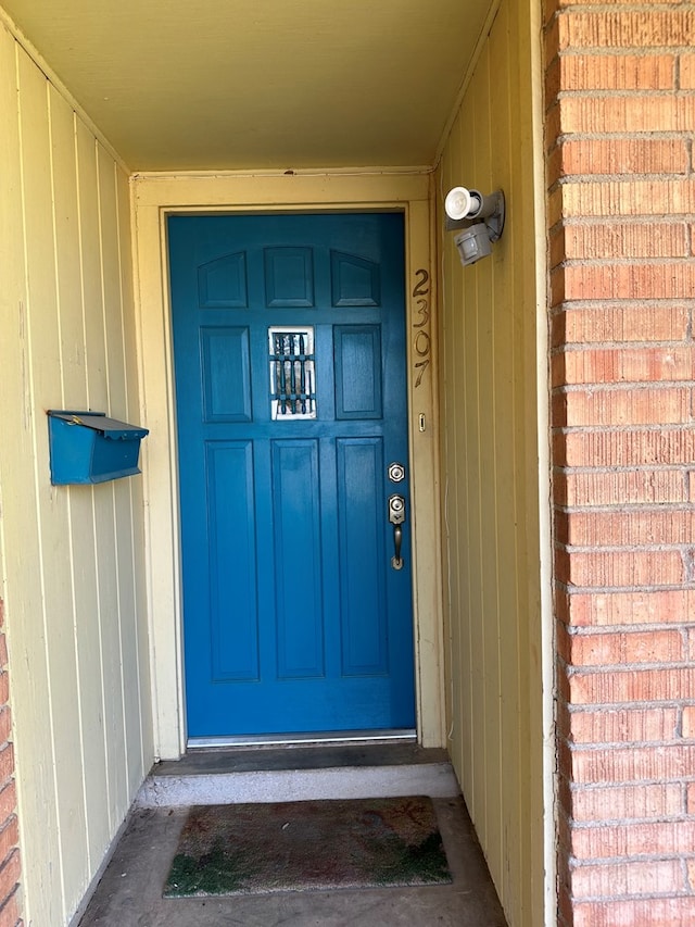 entrance to property with brick siding