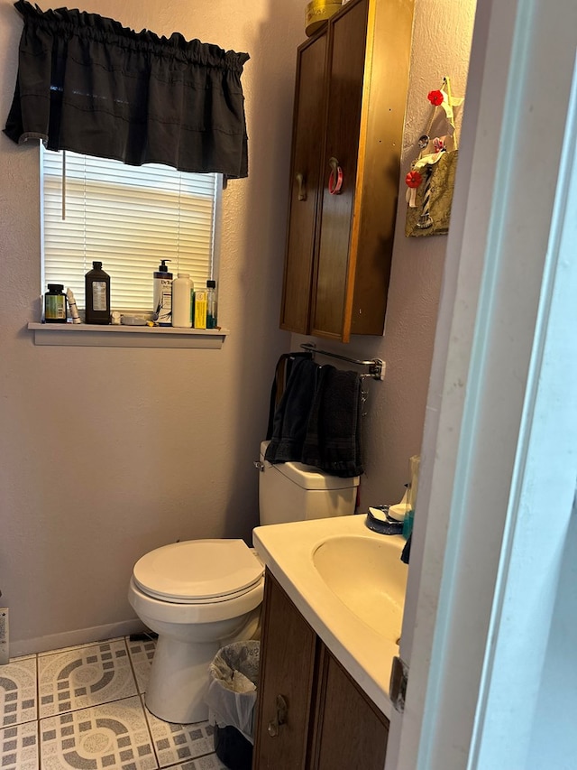 bathroom featuring tile patterned flooring, vanity, and toilet