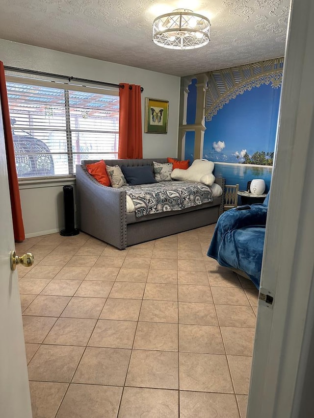 tiled bedroom featuring baseboards and a textured ceiling