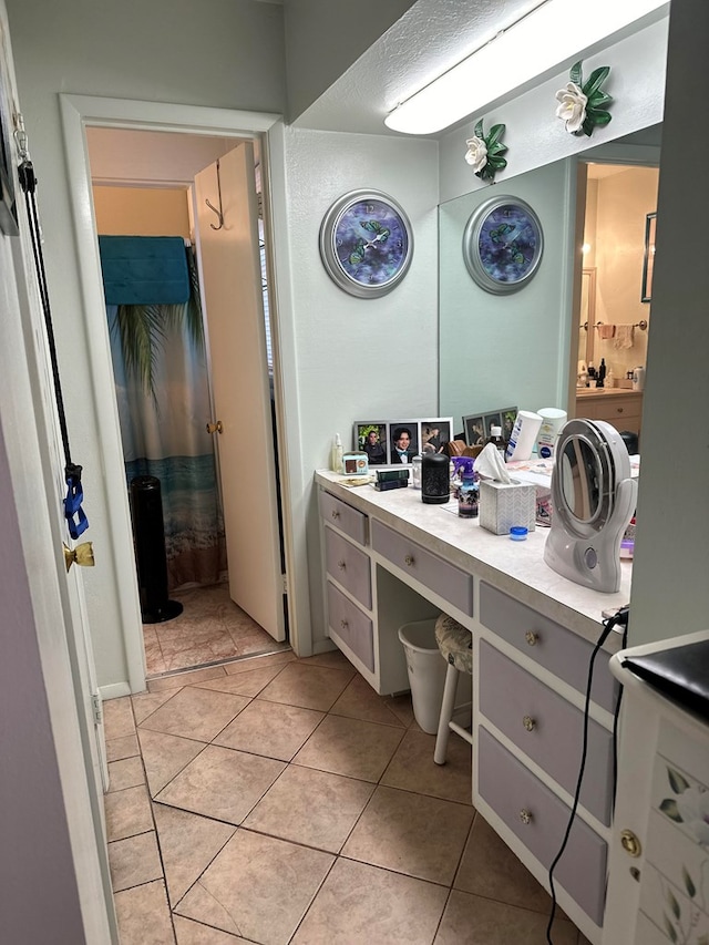 bathroom with tile patterned flooring and vanity