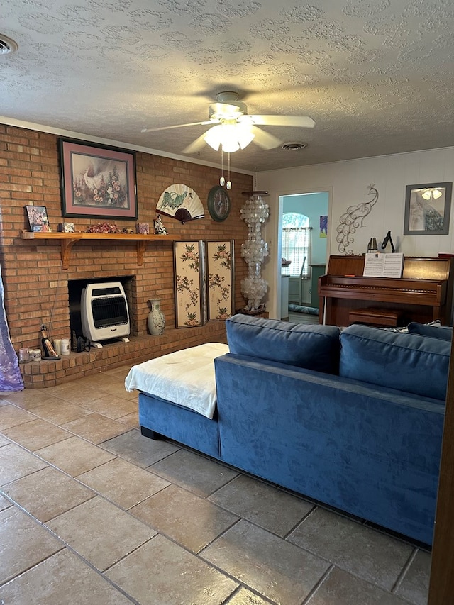 living room featuring ceiling fan, a fireplace, and a textured ceiling