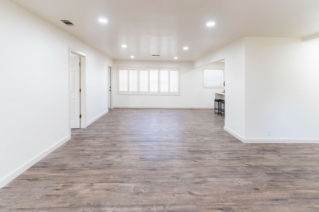 empty room with visible vents, baseboards, wood finished floors, and recessed lighting