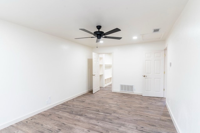 spare room with visible vents, baseboards, and wood finished floors