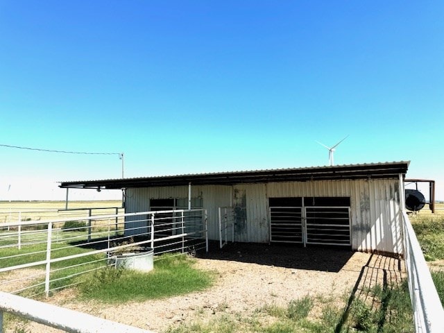 view of horse barn with a rural view