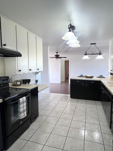 kitchen with white cabinetry, electric range, hanging light fixtures, and range hood