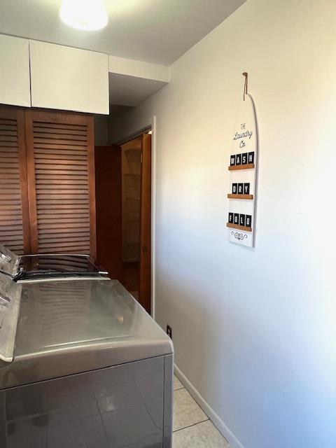 laundry area featuring light tile patterned flooring and separate washer and dryer