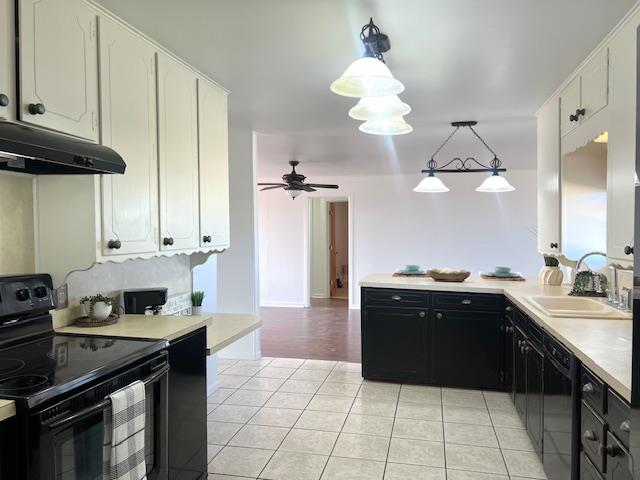 kitchen featuring ceiling fan, sink, pendant lighting, white cabinets, and black appliances