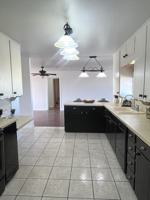 kitchen with dishwasher, white cabinets, decorative light fixtures, and light tile patterned floors