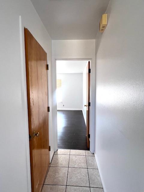 hall with light tile patterned floors