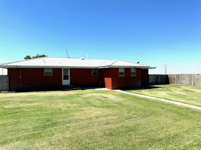 back of house with a lawn