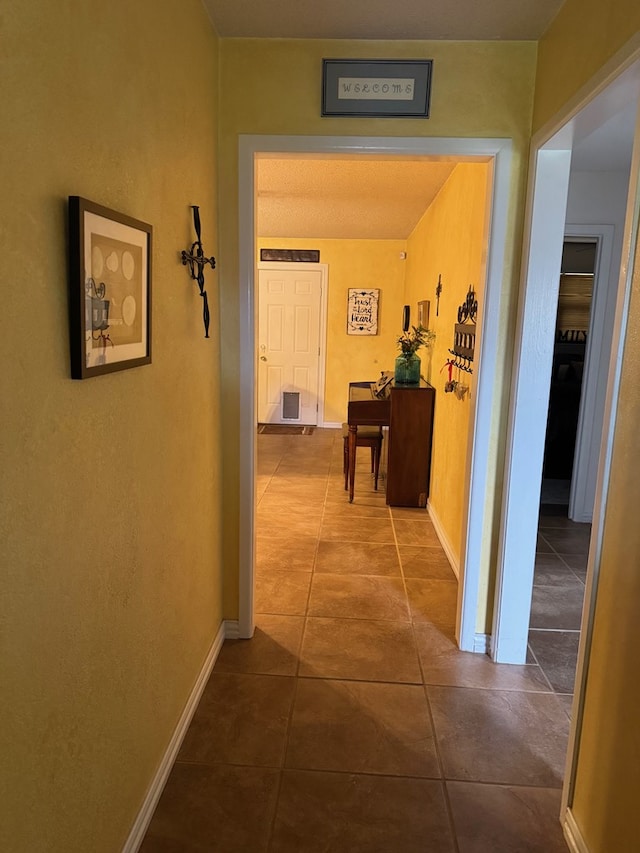1512 W 14th St, Fort Stockton, TX 79735 - hall featuring dark tile patterned floors and baseboards