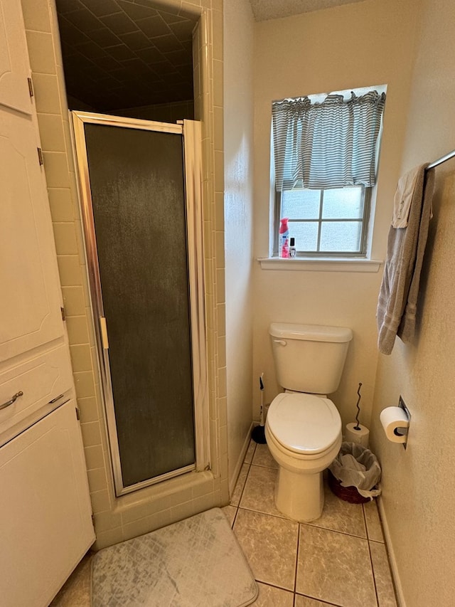 1512 W 14th St, Fort Stockton, TX 79735 - bathroom with tile patterned flooring, a shower stall, baseboards, and toilet
