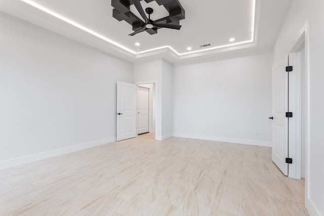 unfurnished room featuring a raised ceiling