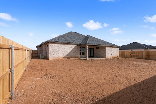 rear view of property with central AC unit