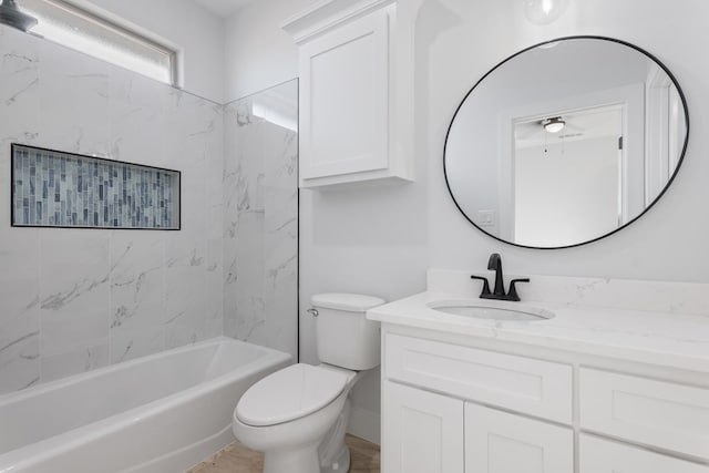 full bathroom featuring tiled shower / bath combo, vanity, and toilet