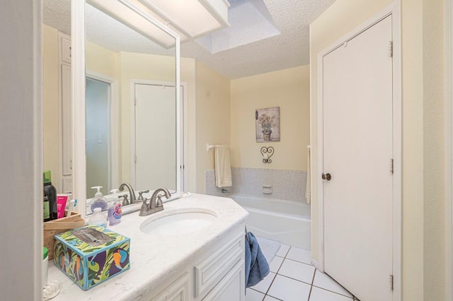 4704 Elma Dr, Midland, TX 79707 - full bath featuring vanity, tile patterned floors, a textured ceiling, and a garden tub