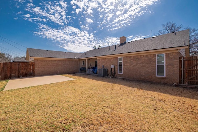 4704 Elma Dr, Midland, TX 79707 - rear view of house with central AC, a patio area, brick siding, and a chimney