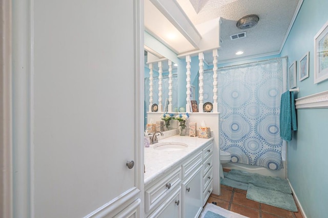 4704 Elma Dr, Midland, TX 79707 - full bath with vanity, toilet, tile patterned flooring, and a textured ceiling