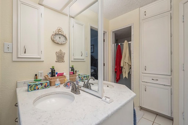 4704 Elma Dr, Midland, TX 79707 - bathroom with vanity, tile patterned flooring, and a textured ceiling