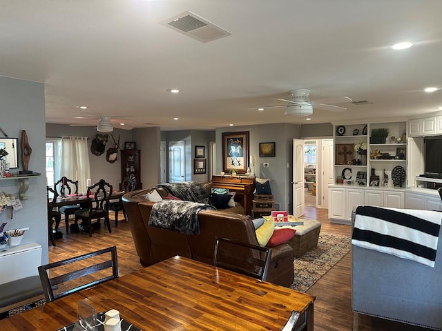 living room featuring dark hardwood / wood-style flooring and ceiling fan