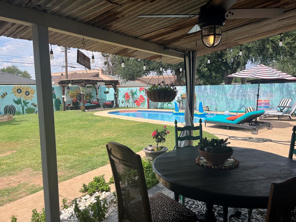 view of patio / terrace with outdoor dining space, a fenced in pool, a fenced backyard, ceiling fan, and a gazebo